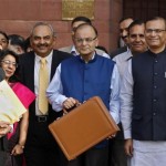 India's FM Jaitley poses as he leaves his office to present the 2015/16 federal budget in New Delhi